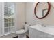 Clean bathroom with white vanity, toilet and mirror at 729 Meadow Lake Dr, Matthews, NC 28105