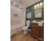 Updated bathroom with stylish green plank wall and modern vanity at 7493 Water Haven Trl, Denver, NC 28037