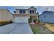 Two-story house with attached garage and landscaped front yard at 8316 Kneller St, Charlotte, NC 28215