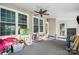 Covered porch with multiple windows and ceiling fan at 11918 Sir Francis Drake Dr, Charlotte, NC 28277