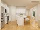 Modern kitchen with white cabinets, island, and breakfast bar at 1603 Croyden St, Indian Land, SC 29707