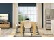 Bright dining room featuring a light wood table and white chairs near a window at 1604 Cannonball Ln, Bessemer City, NC 28016