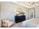 Main bedroom showcases a cozy armchair and a large round mirror above a dresser at 2113 Bayou Trace Dr, Charlotte, NC 28262