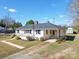 White brick ranch home with gray roof, detached shed, and landscaped yard at 2274 Nc 109 S Hwy, Wadesboro, NC 28170