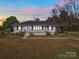 White brick ranch house with gray roof, spacious lawn, and covered porch at 2274 Nc 109 S Hwy, Wadesboro, NC 28170