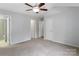 Primary bedroom with ceiling fan, carpet, and access to bath at 229 Arlington Downs Blvd, Matthews, NC 28104