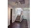 Bright entryway with staircase, dark hardwood floors, and coat closet at 229 Arlington Downs Blvd, Matthews, NC 28104