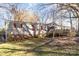 Single-wide manufactured home with a deck and large trees in the yard at 334 Hillcrest Dr, Mooresville, NC 28115