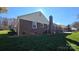 Rear view of brick home showcasing landscaping and driveway at 433 Pamela St, Gastonia, NC 28054