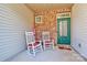 Cozy front porch with rocking chairs and brick exterior at 5021 Mockernut Ln, Fort Mill, SC 29707