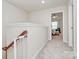 Upstairs hallway with carpeted flooring and access to bedrooms at 5021 Mockernut Ln, Fort Mill, SC 29707