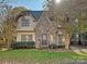 Two-story home with stone accents and a landscaped lawn at 820 Millbrook Rd, Charlotte, NC 28211