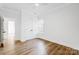 Light-filled bedroom featuring hardwood floors and double doors at 901 Edgemont Ave, Belmont, NC 28012