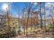 Landscaped backyard with lake view and autumn foliage at 9066 Tulagi Ct, Tega Cay, SC 29708