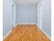 Simple bedroom with hardwood floors and light blue walls at 9066 Tulagi Ct, Tega Cay, SC 29708