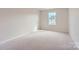 Simple bedroom with neutral walls, carpet, and a window at 9732 Inkberry Dr, Gastonia, NC 28056