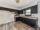 Galley kitchen featuring dark cabinets and granite countertops at 1006 Wooddale Ct, Dallas, NC 28034