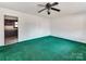 Spacious living room with green carpet and ceiling fan at 1006 Wooddale Ct, Dallas, NC 28034