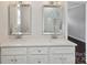 Double vanity bathroom with quartz countertops and large mirrors at 104 Vista Dr, Davidson, NC 28036