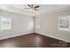 Bright bedroom with dark hardwood floors and plantation shutters at 104 Vista Dr, Davidson, NC 28036