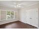 Bright bedroom with hardwood floors, plantation shutters, and double doors at 104 Vista Dr, Davidson, NC 28036
