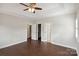 Bright bedroom featuring hardwood floors and multiple doors leading to other rooms at 104 Vista Dr, Davidson, NC 28036