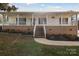 Brick and white house with a covered porch and steps at 104 Vista Dr, Davidson, NC 28036