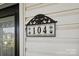 Image of house number 104 on a wall-mounted plaque at 104 Vista Dr, Davidson, NC 28036