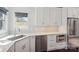 White shaker cabinets, corner sink, and stainless steel appliances at 104 Vista Dr, Davidson, NC 28036