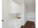 Laundry room with white cabinets, quartz countertops, and shelving at 104 Vista Dr, Davidson, NC 28036