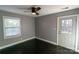 Gray bedroom with dark hardwood floors, ceiling fan, and exterior access at 1228 Matheson Ave, Charlotte, NC 28205