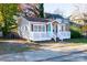 Quaint bungalow with gray siding, white deck, and a teal front door at 1228 Matheson Ave, Charlotte, NC 28205