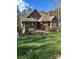 Two-story house with a covered porch and stone accents, situated on a landscaped lawn at 1327 Moonshadow Ln, Shelby, NC 28150