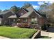 Two-story house with stone and red siding, landscaped lawn, and driveway at 1327 Moonshadow Ln, Shelby, NC 28150