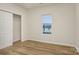 Bright bedroom with wood-look floors, large closet, and a window offering natural light at 1423 Roseland Dr, Lincolnton, NC 28092