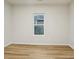 Well-lit bedroom, featuring wood-look floors and a window at 1423 Roseland Dr, Lincolnton, NC 28092