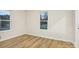 Bedroom with two windows and wood-look floors at 1423 Roseland Dr, Lincolnton, NC 28092