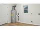 Laundry room with water heater, a window, and a door at 1423 Roseland Dr, Lincolnton, NC 28092