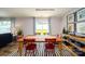 Bright dining room with red chairs and a view of the backyard at 14521 Winged Teal Rd, Charlotte, NC 28278