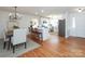 Open concept dining area with hardwood floors and kitchen island at 1509 Redcoat Dr, Charlotte, NC 28211