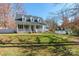 White two-story house with a wraparound porch and detached garage, nicely landscaped yard at 1882 Sardis Dr, Lancaster, SC 29720