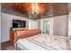 Primary bedroom with wood ceiling, large TV, and a leather bed at 228 Sugar Loaf Dr, Troy, NC 27371