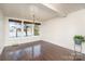Lakefront dining room with hardwood floors and chandelier at 228 Sugar Loaf Dr, Troy, NC 27371