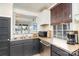 Well-equipped kitchen featuring dark cabinetry and lake views at 228 Sugar Loaf Dr, Troy, NC 27371