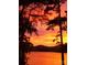 Stunning sunset over calm lake water at 228 Sugar Loaf Dr, Troy, NC 27371