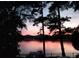Scenic lake view at sunset with a dock at 228 Sugar Loaf Dr, Troy, NC 27371