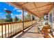 Spacious wooden front porch overlooking tranquil landscape at 27311 Hedge Rd, Albemarle, NC 28001