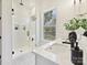 Modern bathroom with double vanity, walk-in shower, and marble floors at 3837 Bon Rea Dr, Charlotte, NC 28226