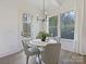 Charming breakfast nook with a round table and gray chairs near sliding glass door at 3837 Bon Rea Dr, Charlotte, NC 28226