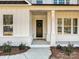 Inviting front porch with a dark brown door and white brick base at 3837 Bon Rea Dr, Charlotte, NC 28226